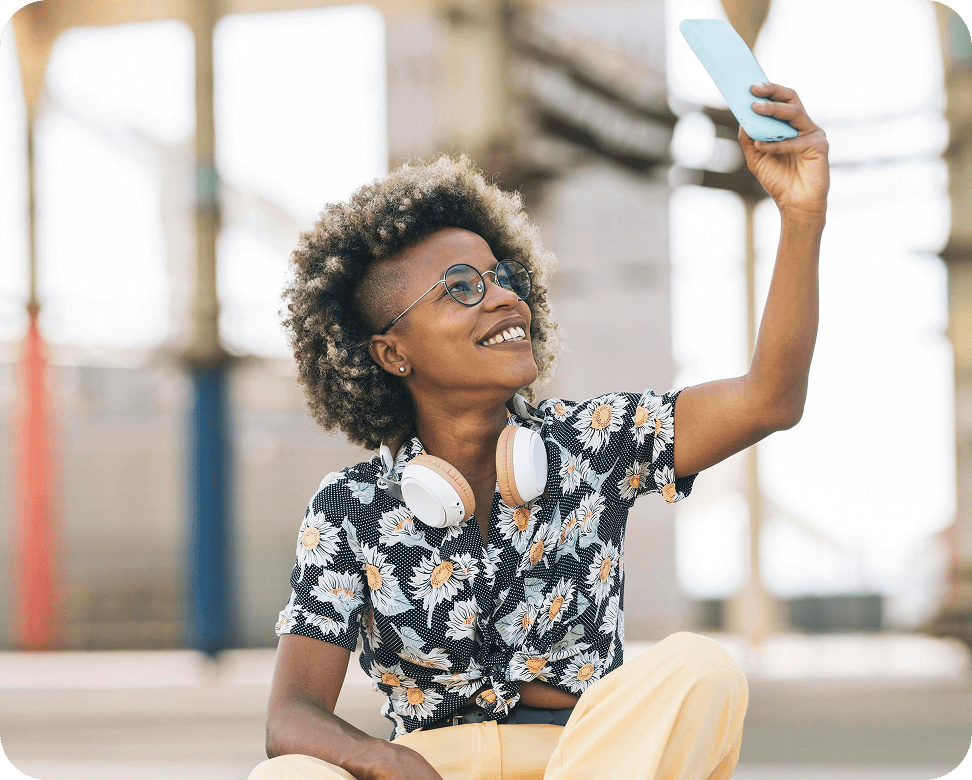 Girl with headphones looking at the phone